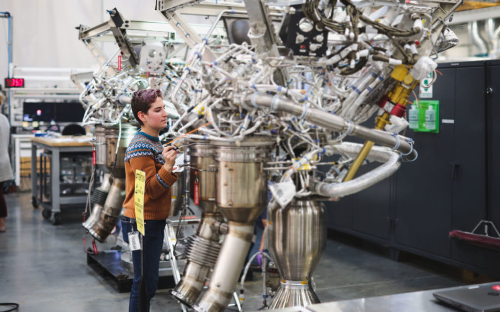 Isabel Cleff inspecting one of the engines she's tested at Virgin Orbit