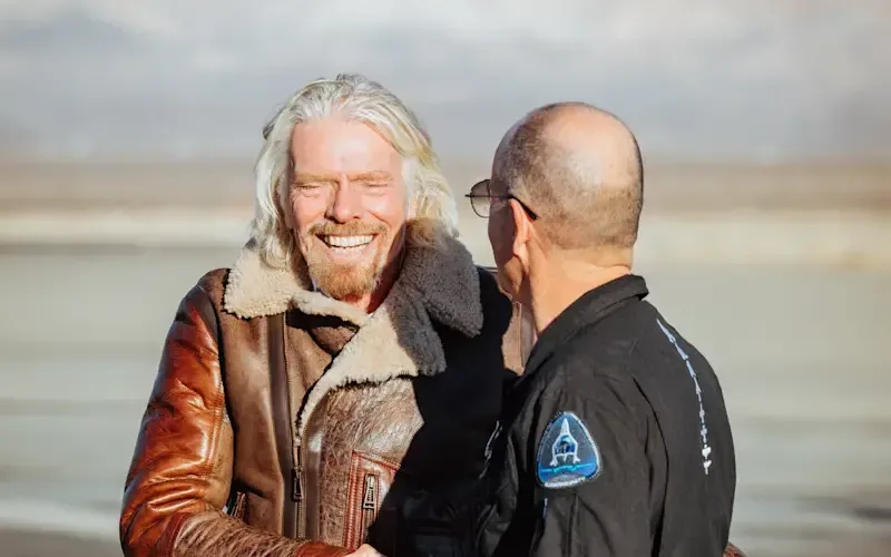 Richard Branson shakes hands with Virgin Galactic pilot Rick "CJ" Sturckow 
