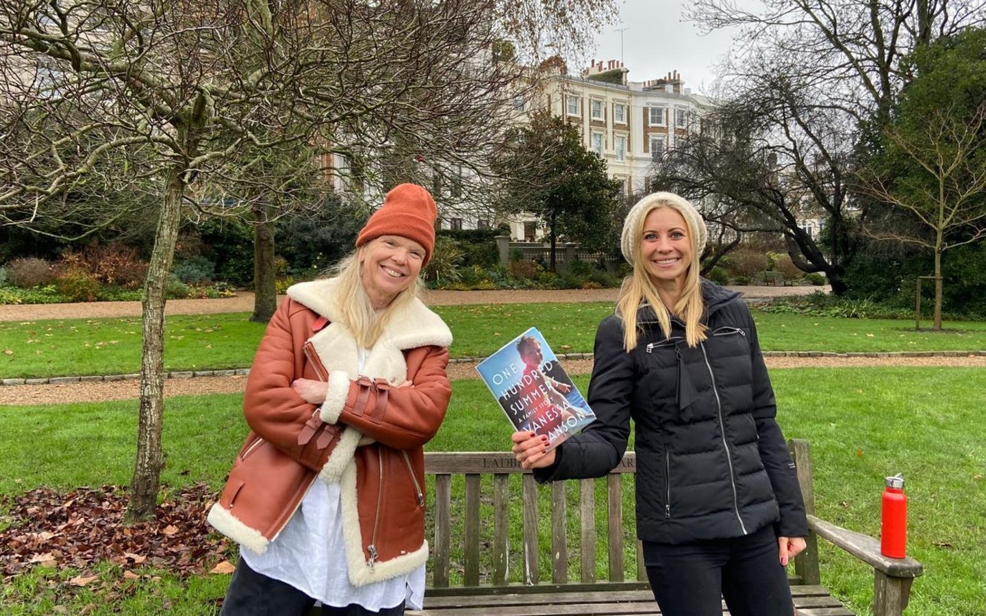 Holly Branson and Vanessa Branson hold up the book copy of One Hundred Summers