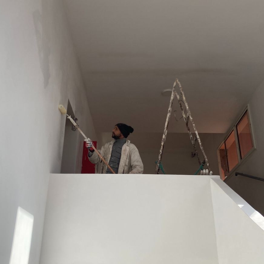 Hassan painting the interior of the repaired study centre | Eve Branson Foundation