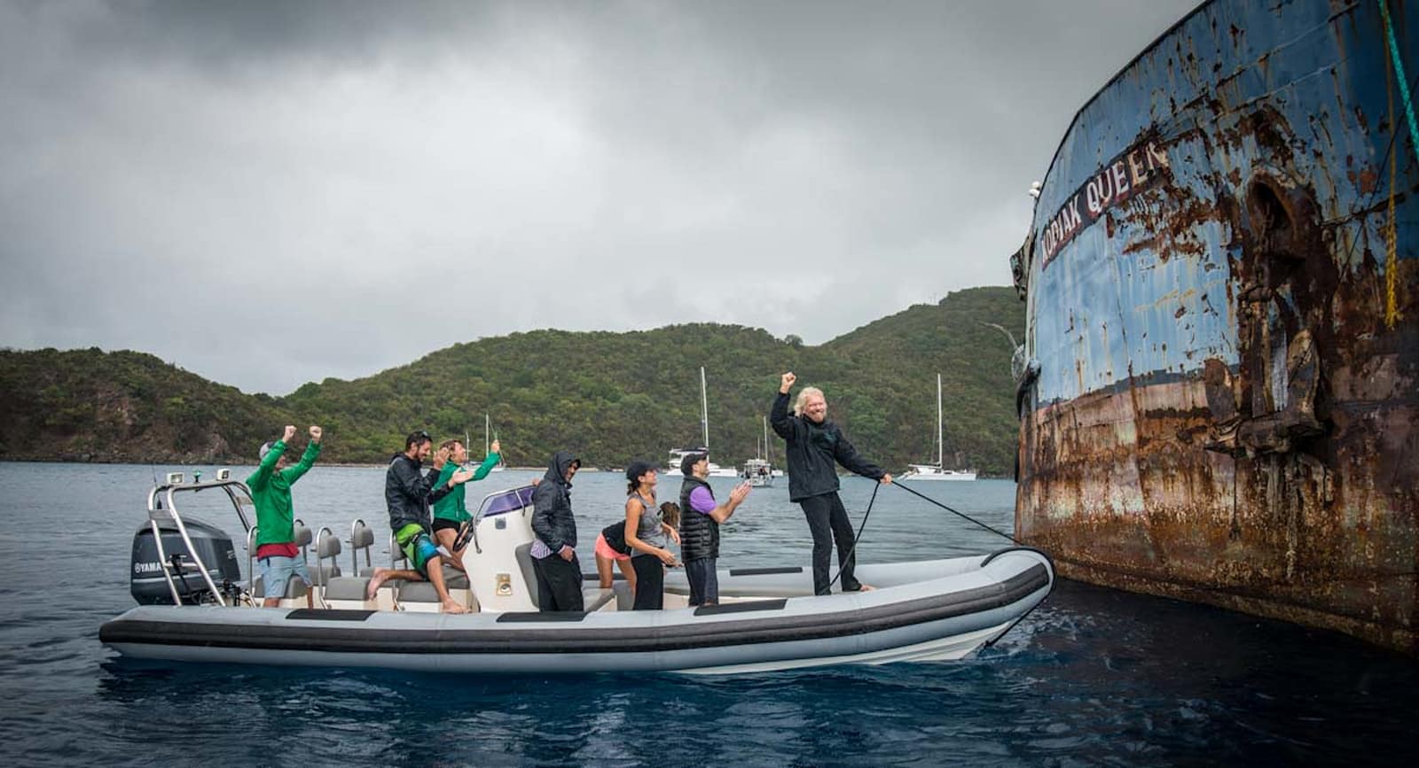 Richard Branson and group on a boat next to the Kodiak Queen 
