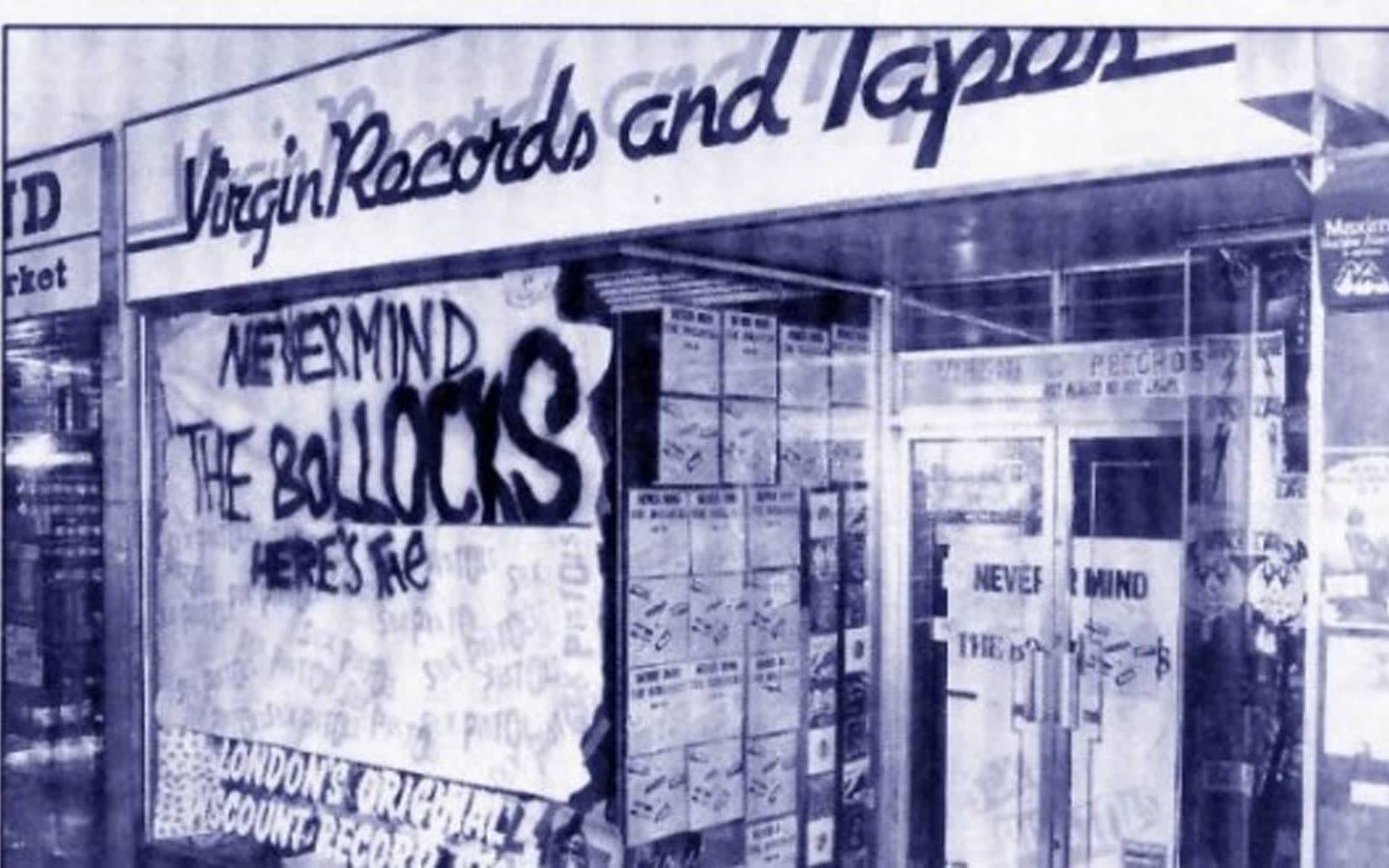 Black and white photo of the storefront of Virgin Records, with graffiti in the window