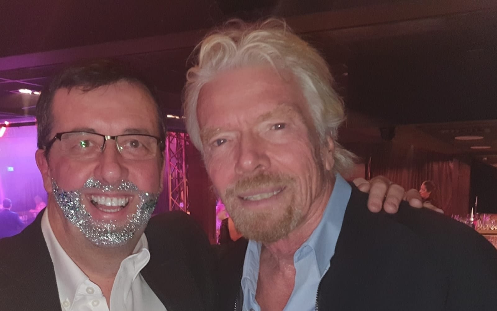 Richard Branson and Darren Jones wearing a glitter beard at Virgin Stars event 