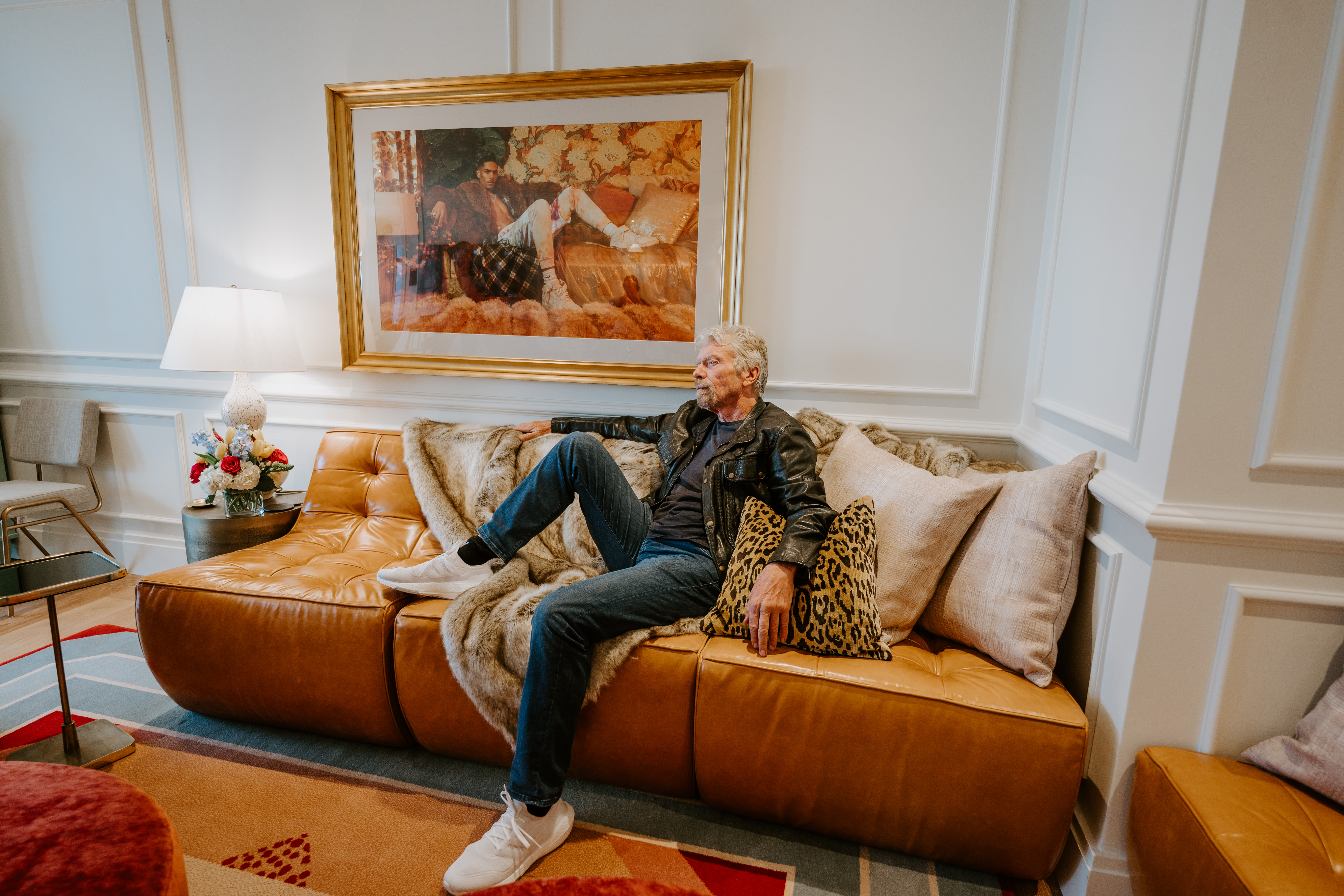Richard Branson sitting on a sofa in a chamber at Virgin Hotels New Orleans