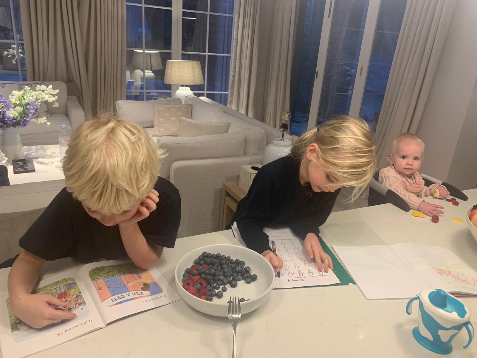 Holly Branson's children doing homework at the table