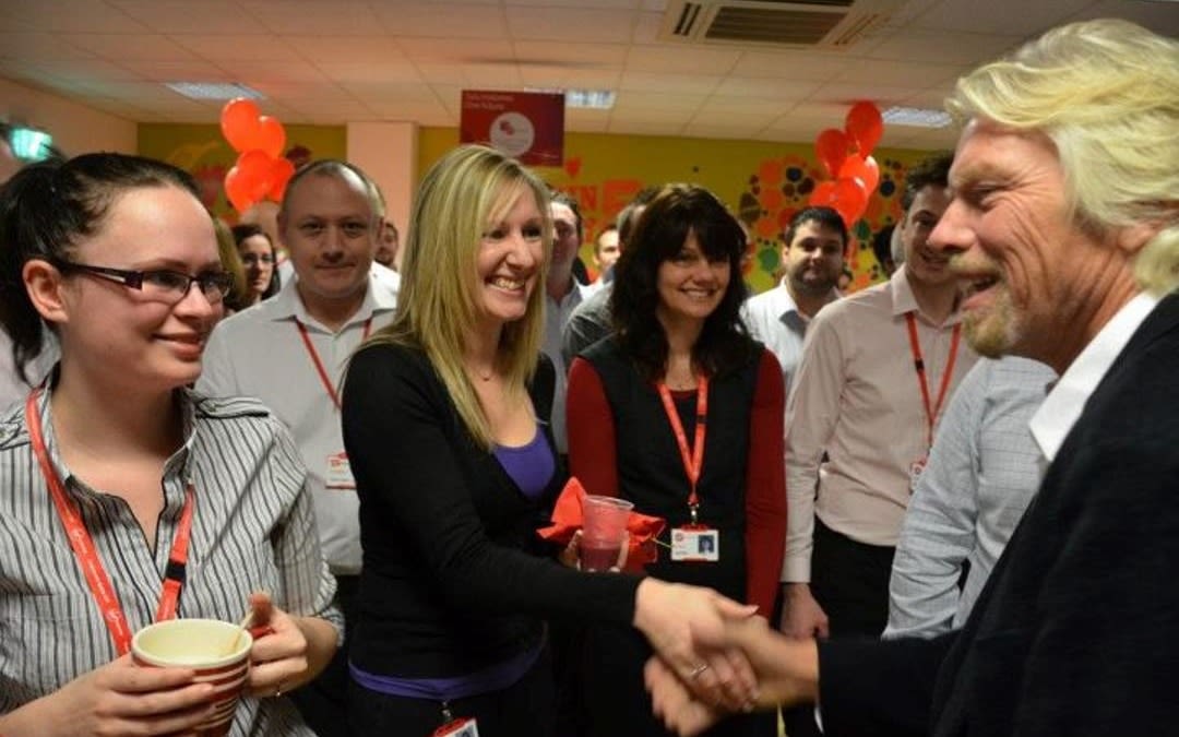 Richad Branson shaking hands with an event with Virgin Money