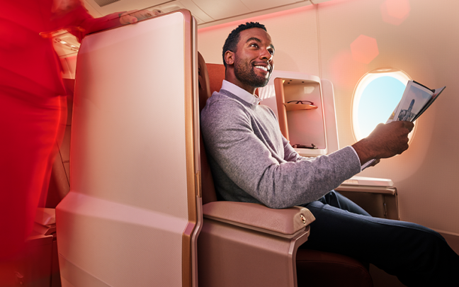 Image of a man in upper class on a Virgin Atlantic flight.
