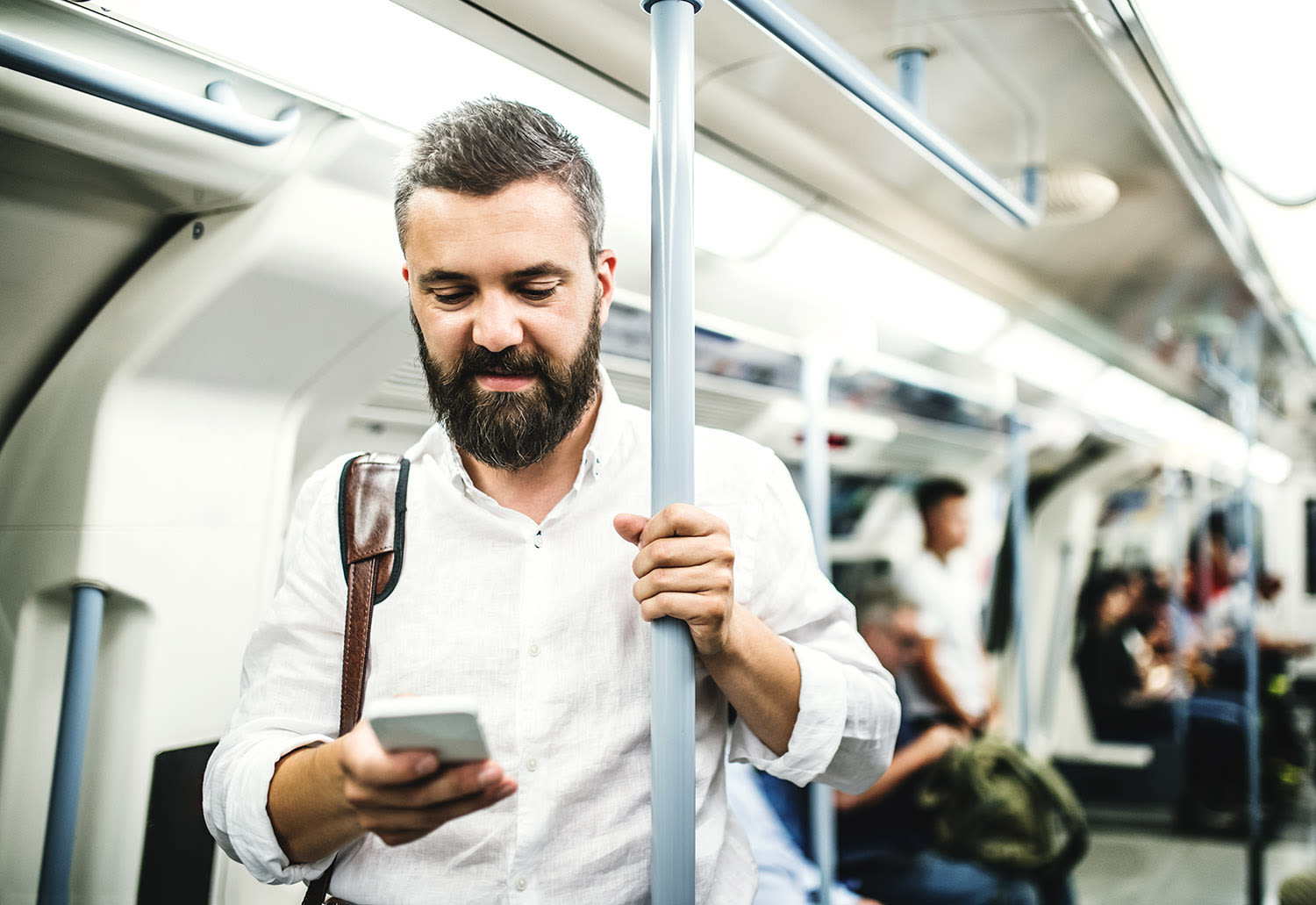 A man using his phone on the London Underground