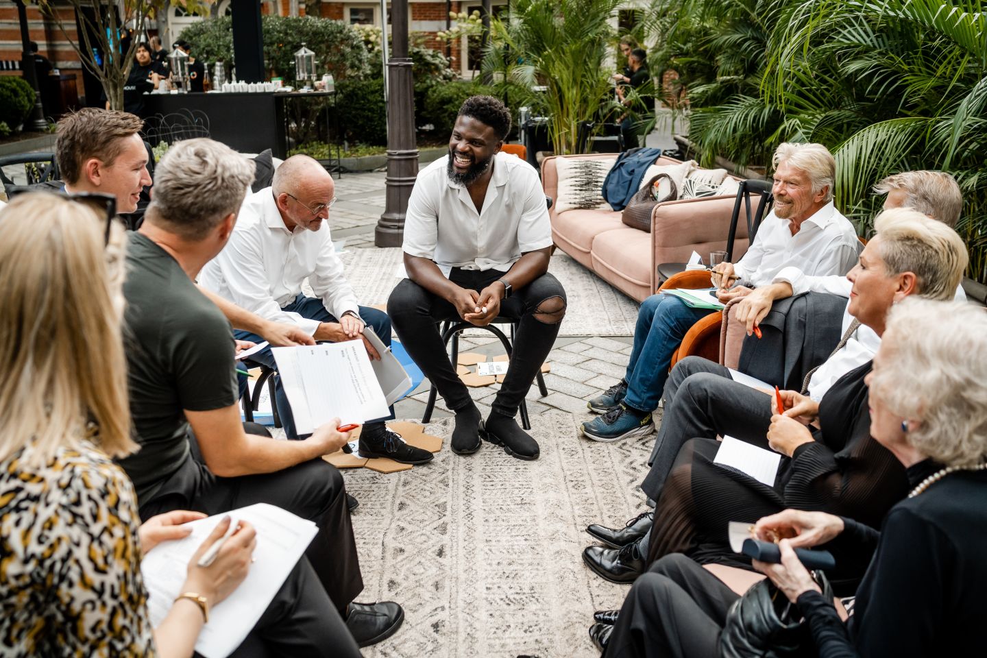 Richard Branson sits with The B Team, young leaders, Karl Lokko, Halla Tomasdottir, Mary Robinson and others in New York