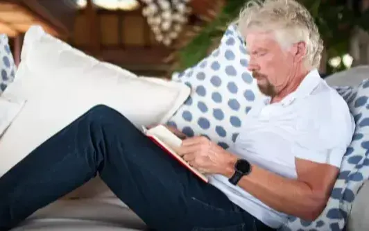 Richard Branson reading a book