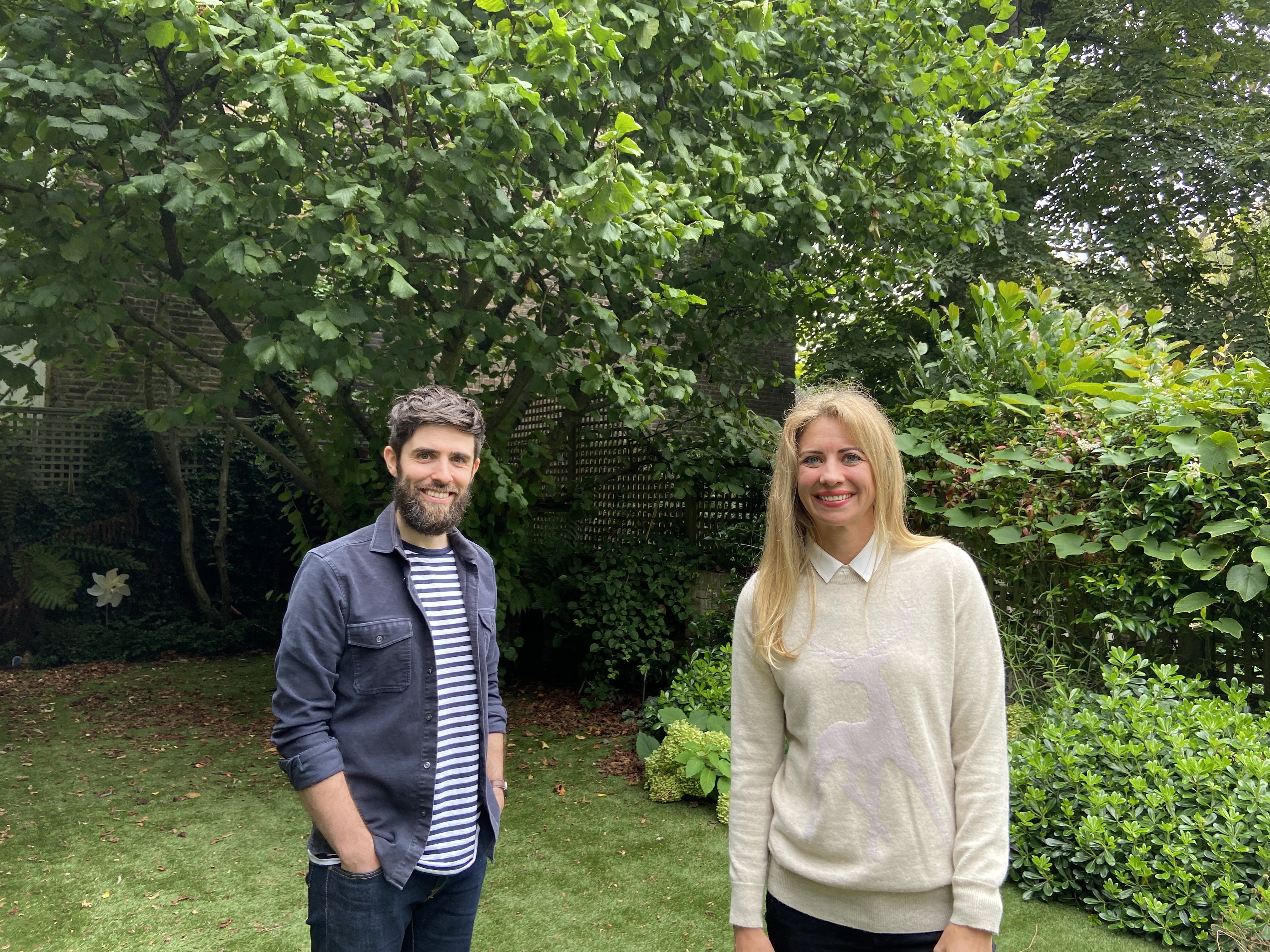 Holly Branson and Virgin StartUp CEO Andy Fishburn smiling in a garden