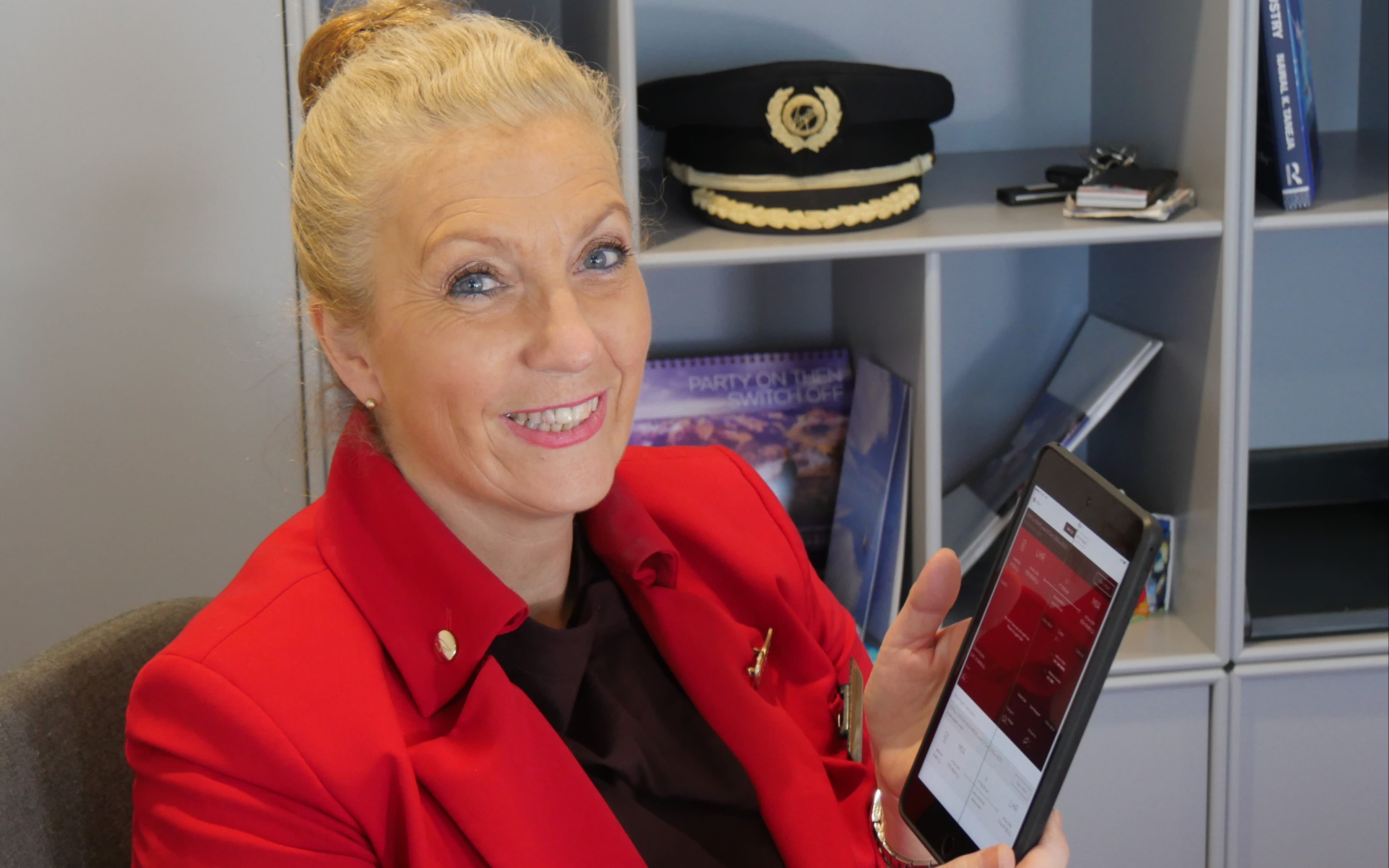 A Virgin Atlantic cabin crew member uses a tablet