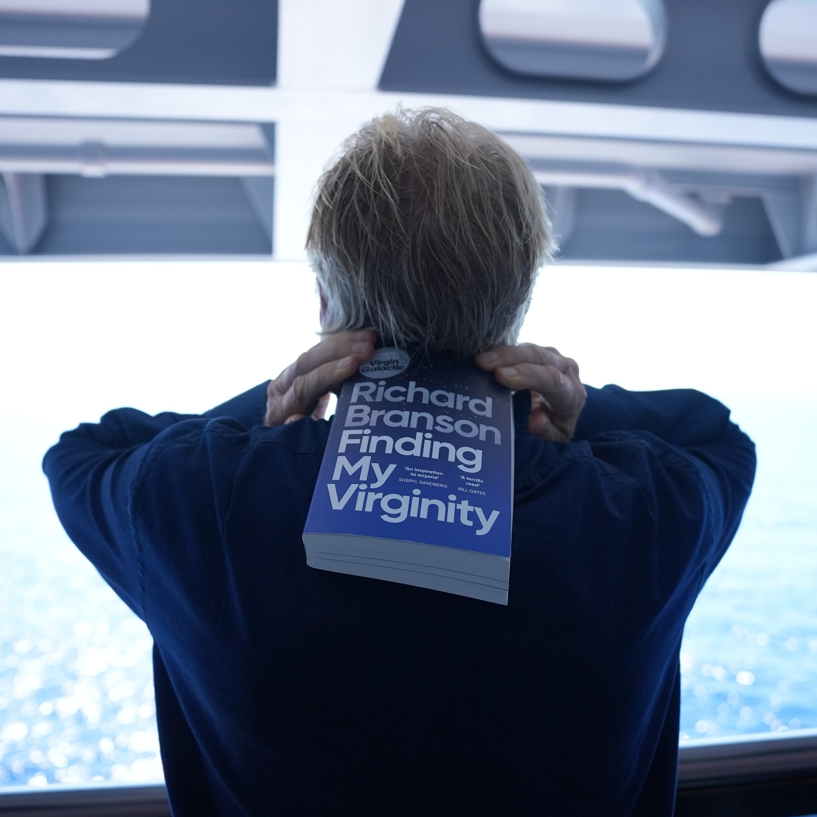 Richard Branson with a copy of my updated autobiography, Finding My Virginity on-board a Virgin Voyages ship