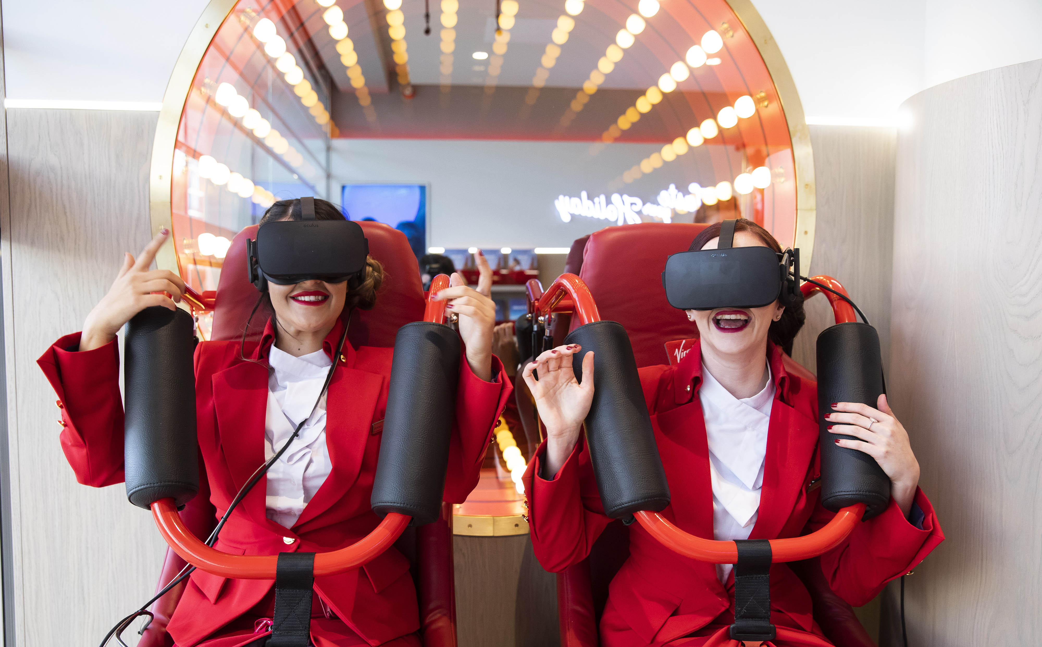 Two Virgin Holidays employees try out the virtual reality rollercoaster at Virgin Holidays V-Room