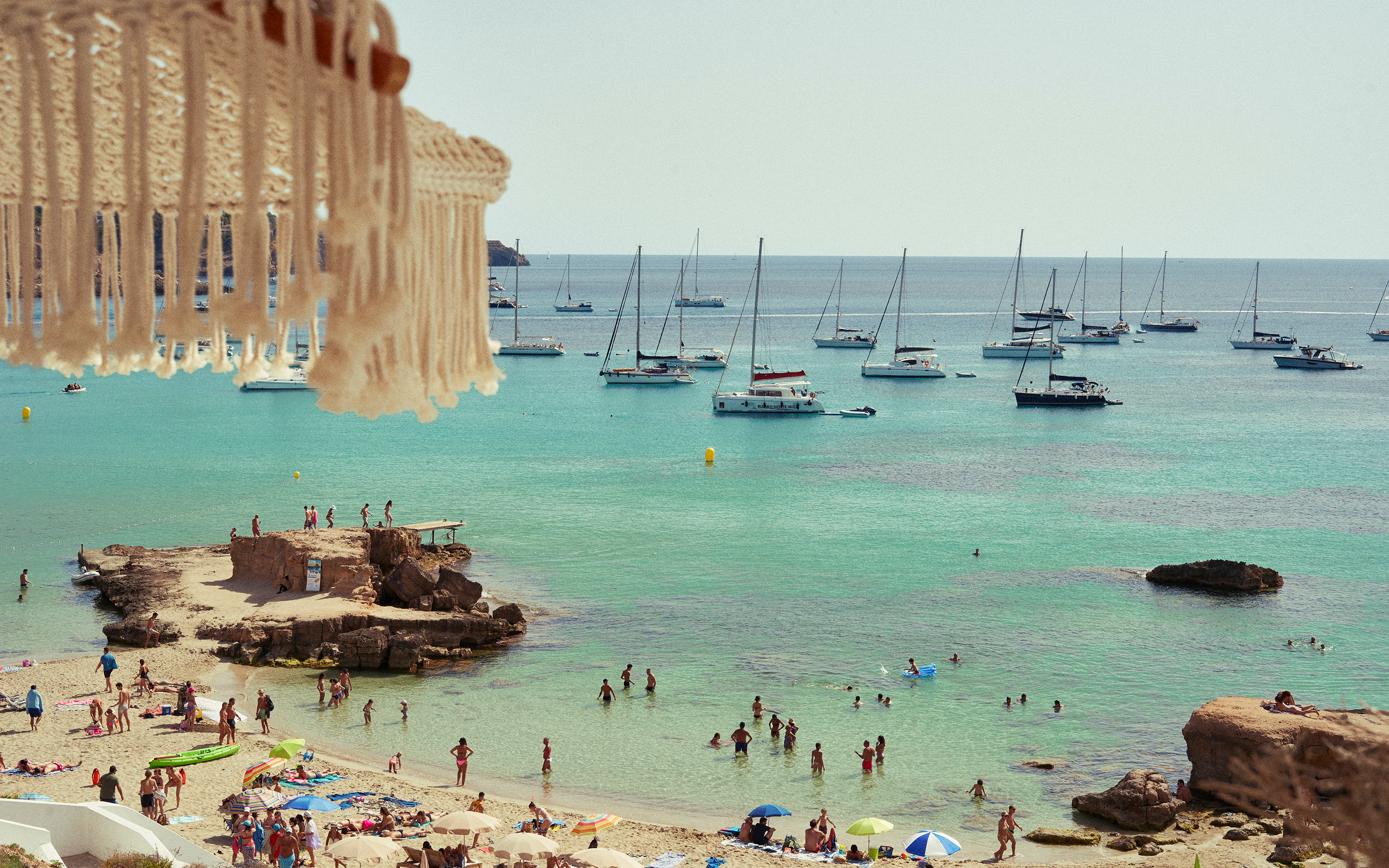 An image of people at a beach in Ibiza