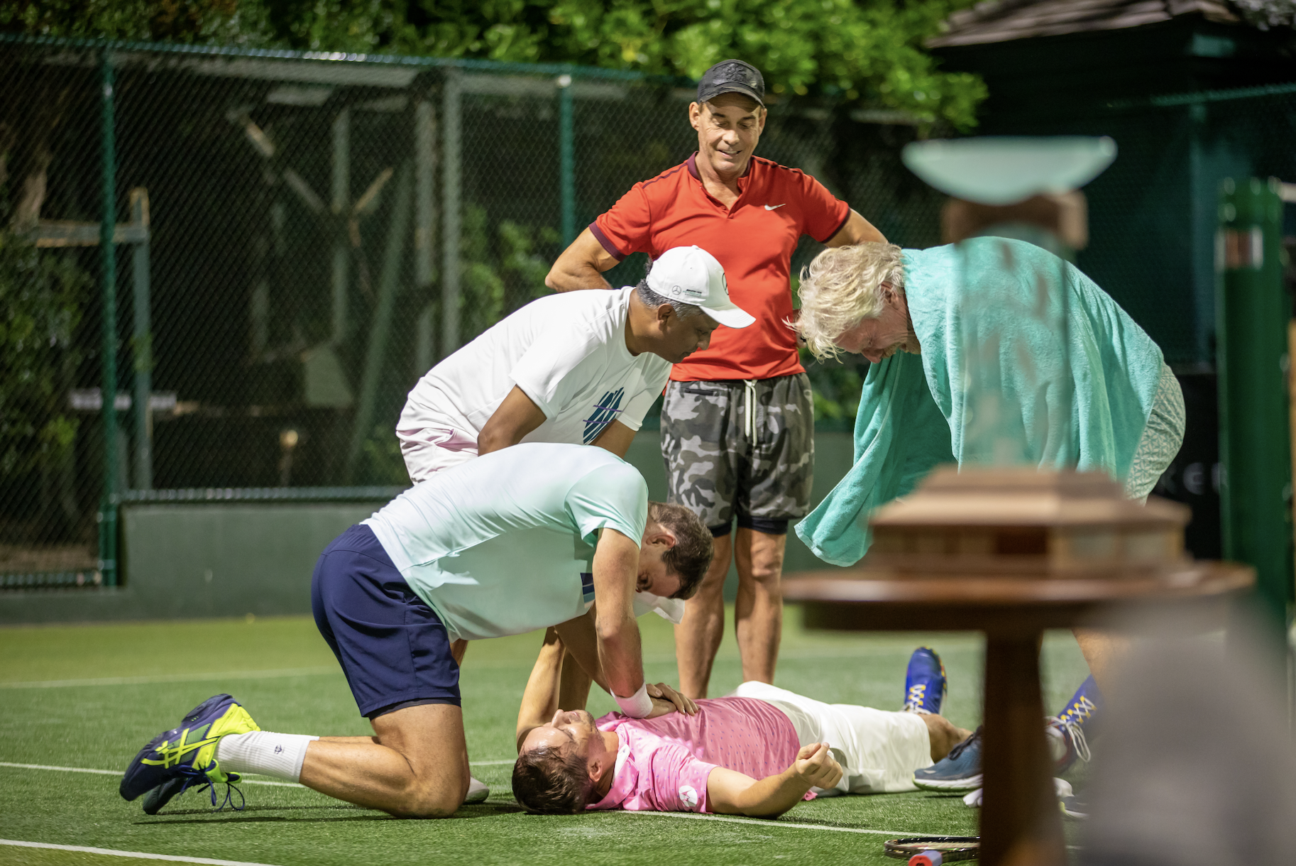 Richard Branson laughing with team mates during the Necker Cup tennis tournament