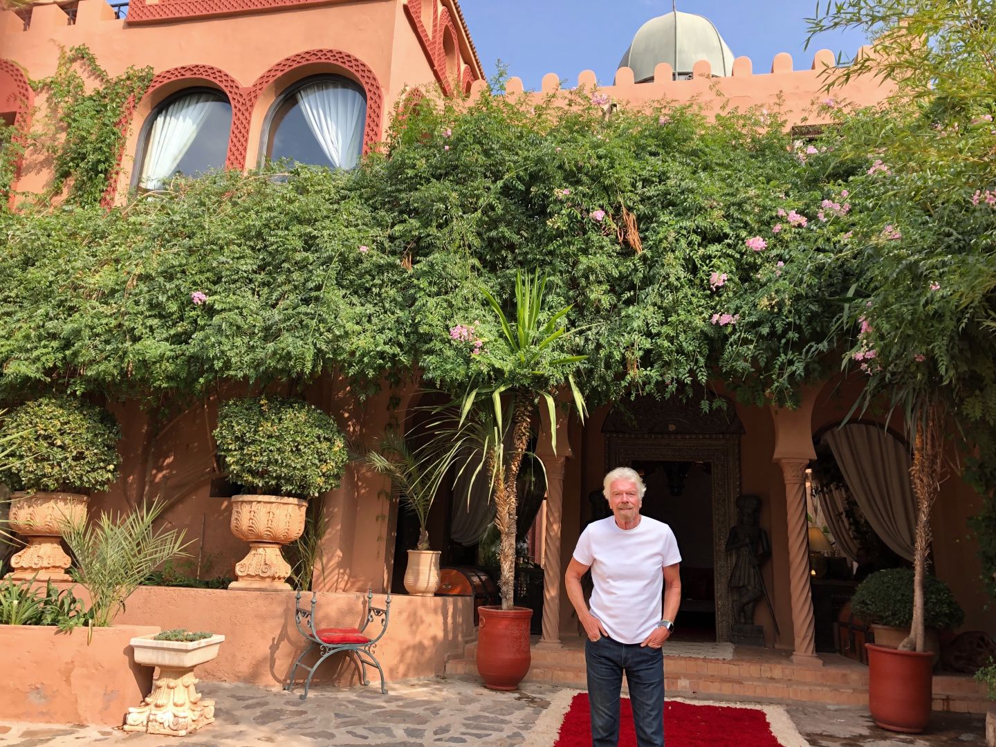 Richard Branson standing outside Kasbah Tamadot in Morocco