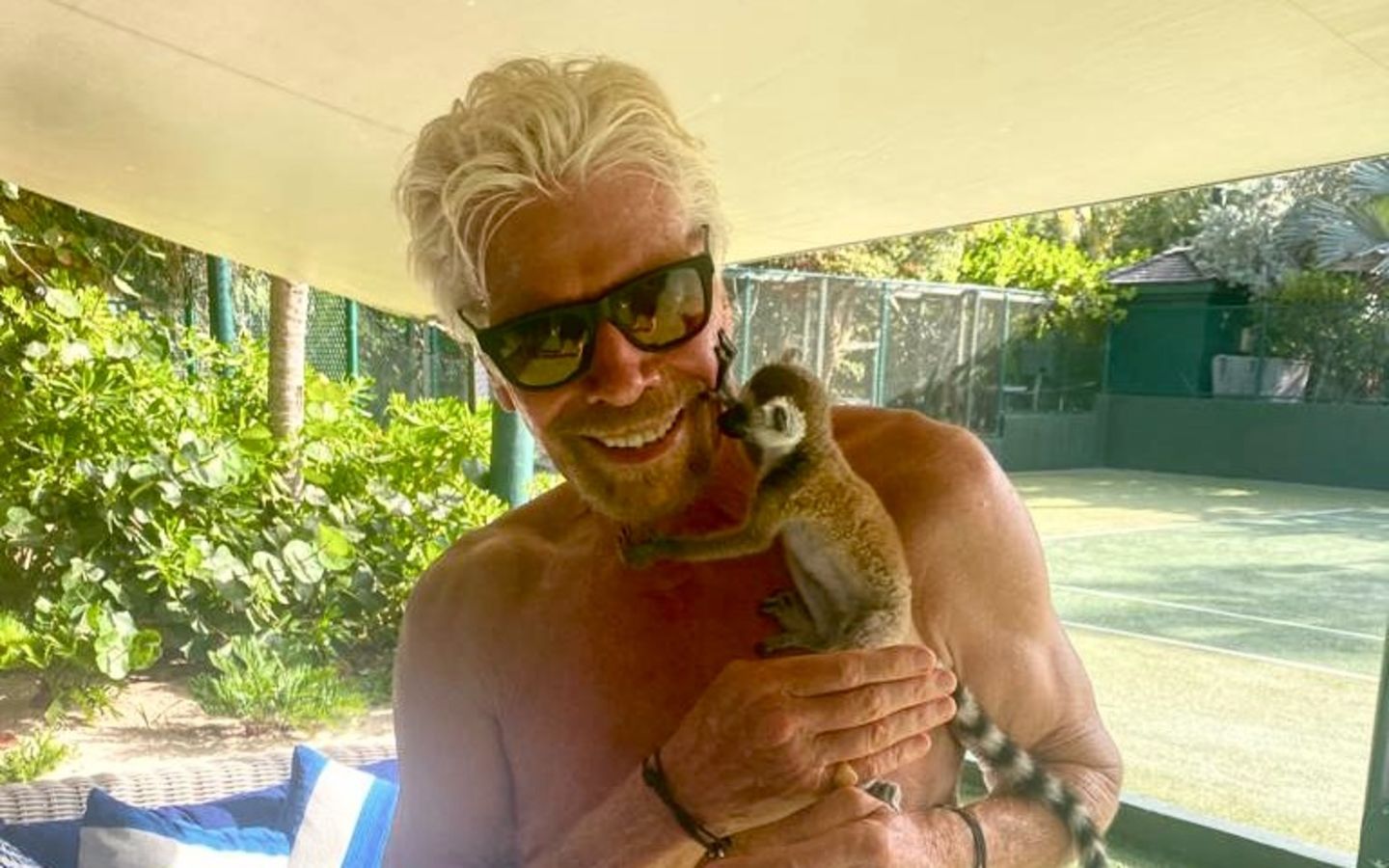 Richard Branson on Necker Island with Pluto the Lemur