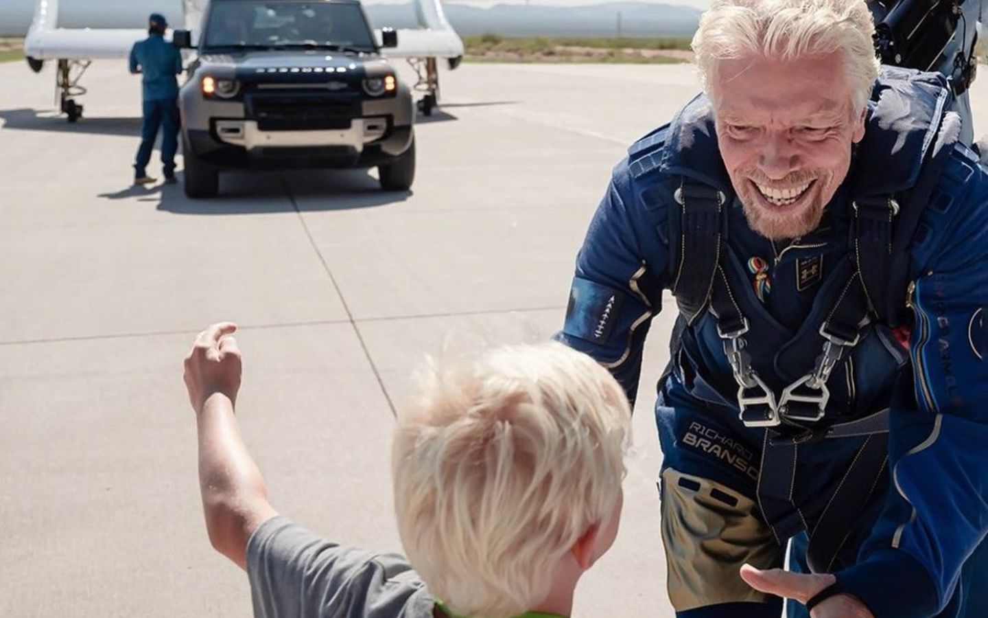 Richard Branson runs to hug his grandson, Artie, after flying to space with Virgi Galactic