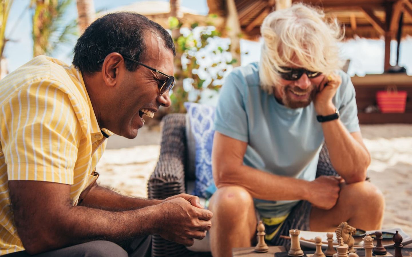 Richard Branson and Mohamed Nasheed laughing and playing chess