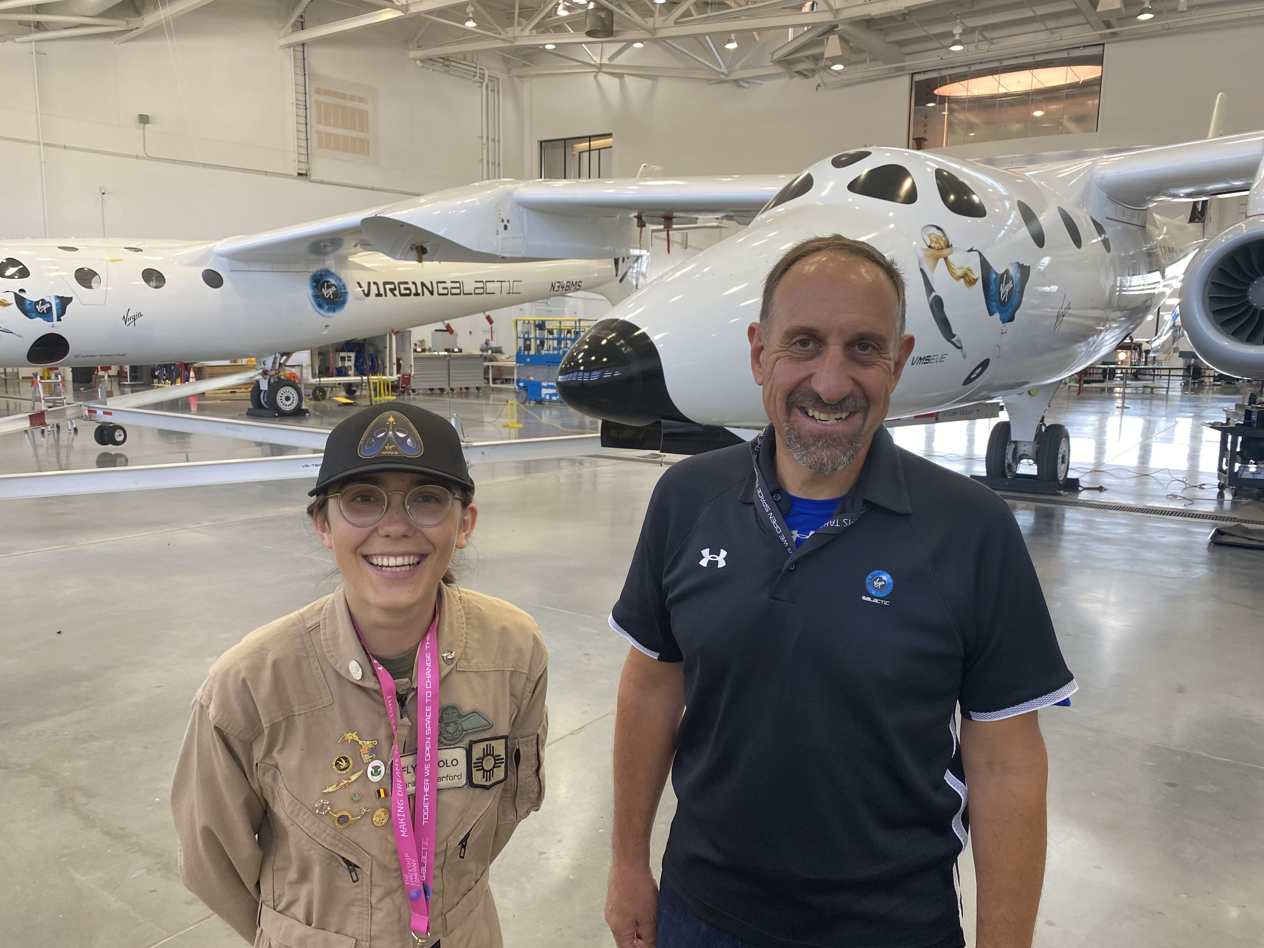 Zara Rutherford smiling next to Virgin Galactic's Michael Masucci