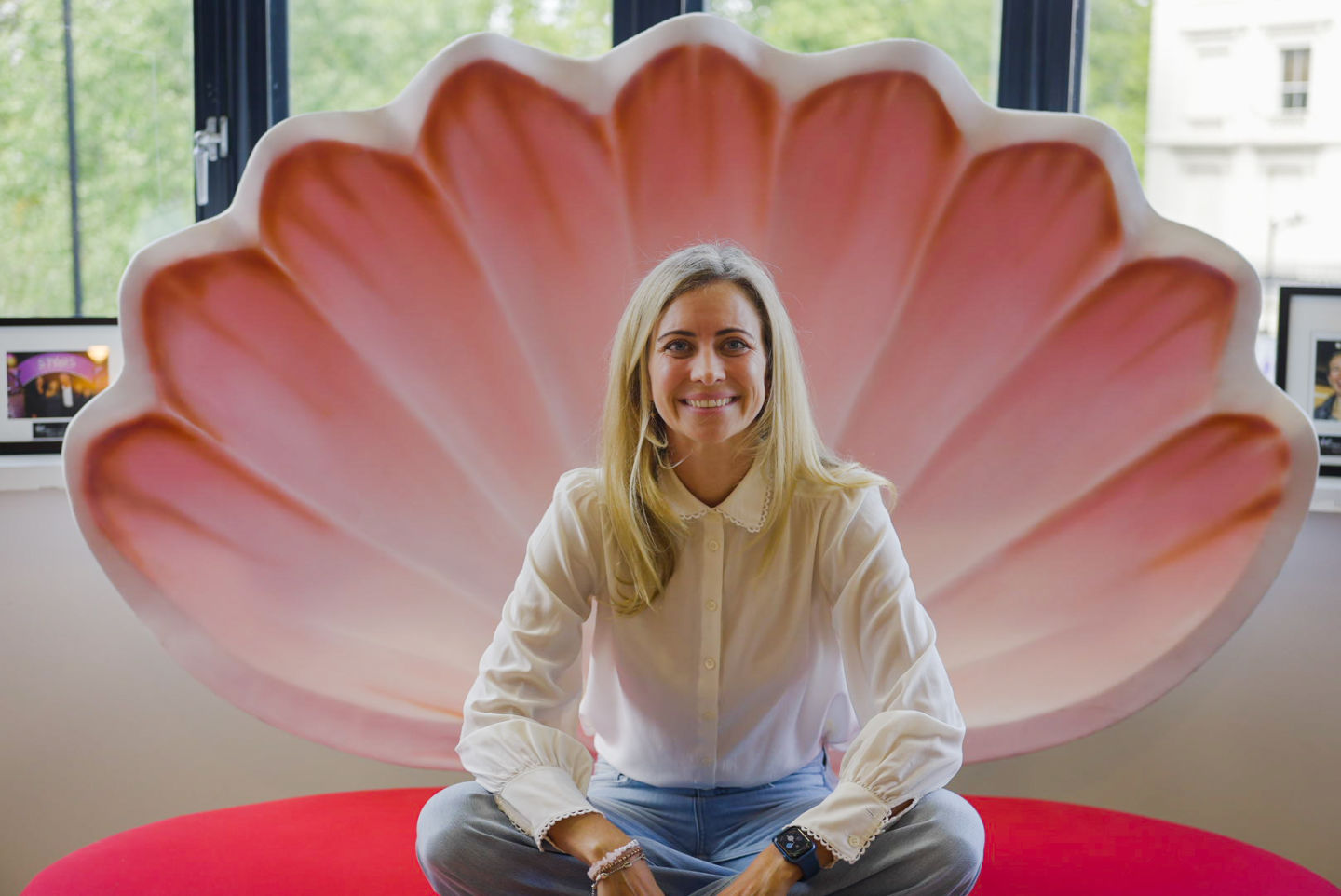 Holly Branson sitting in a gaint seasehll at the Virgin Management office in London