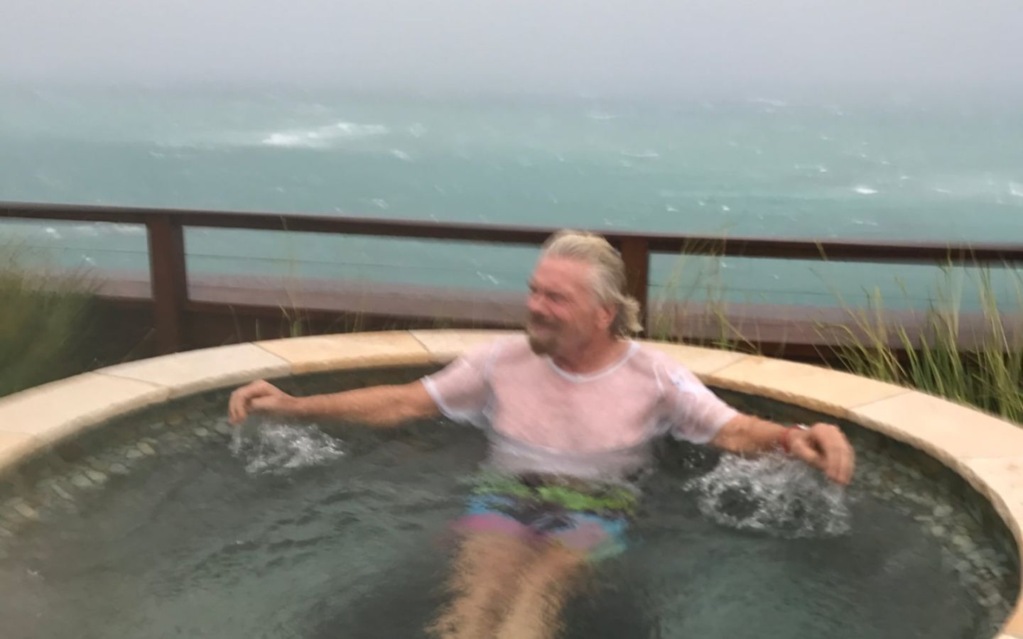 Richard Branson sitting in a hot tub on Necker island