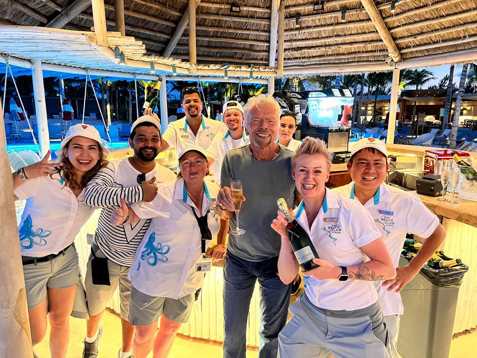 Richard Branson with the crew at Virgin Voyages Bimini beach club