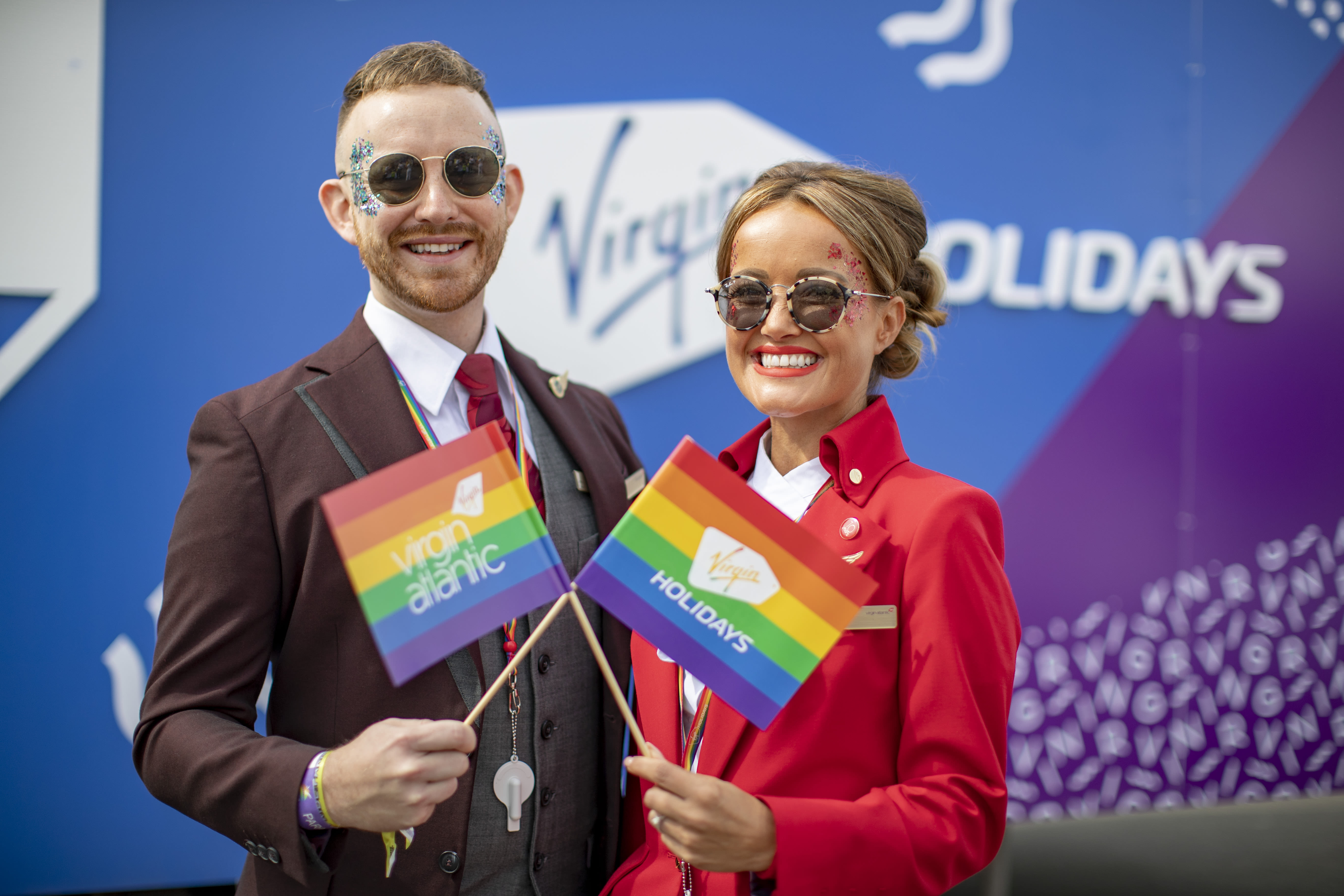 Virgin Atlantic crew waving Pride flags