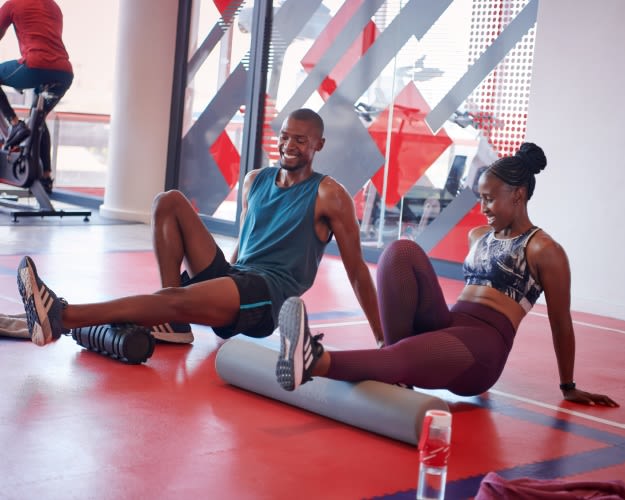 Two people stretching on the training floor at Virgin Active South Africa