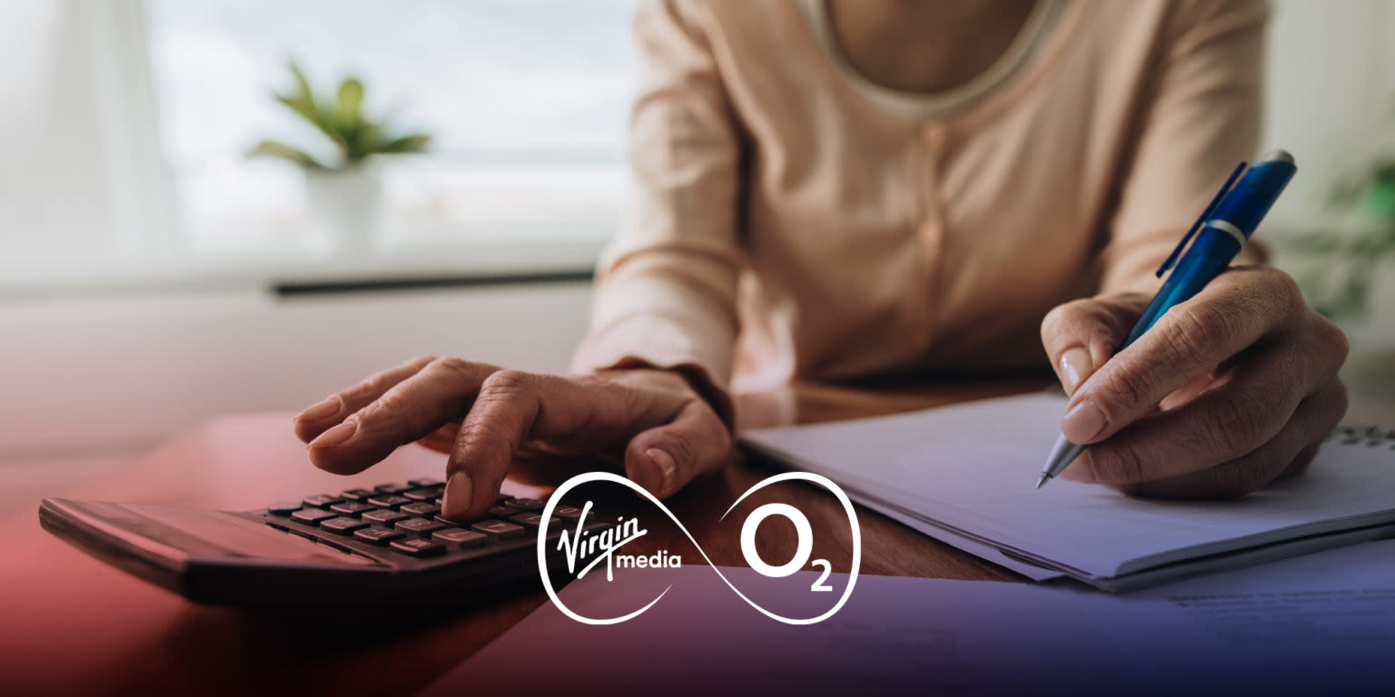 A woman's hands holding a pen and using a calculator with the Virgin Media O2 logo on top of the image