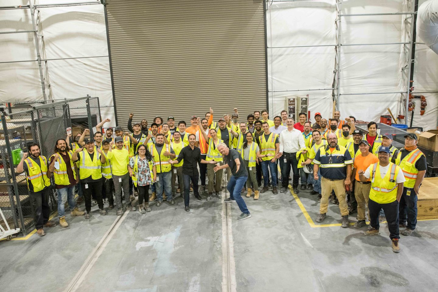 Richard Branson poses for a photo with the Virgin Hyperloop team