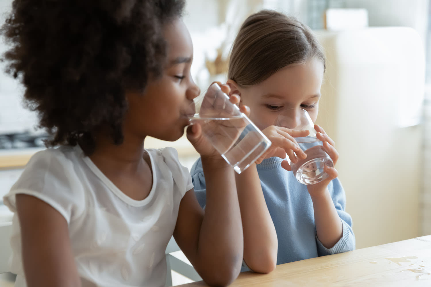 Two girls drinking water