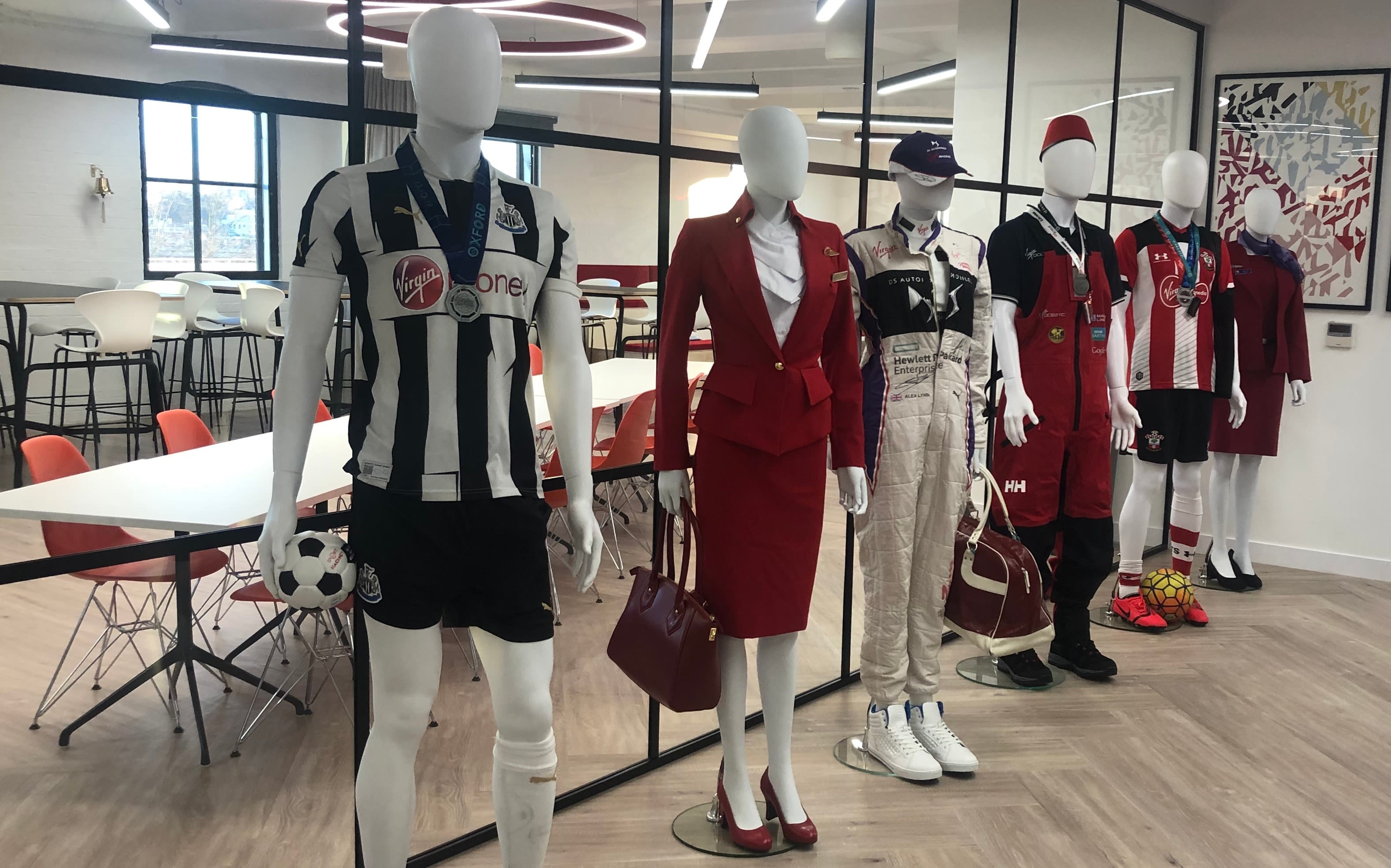 Mannequins wearing Virgin uniform and clothes with Virgin sponsor on