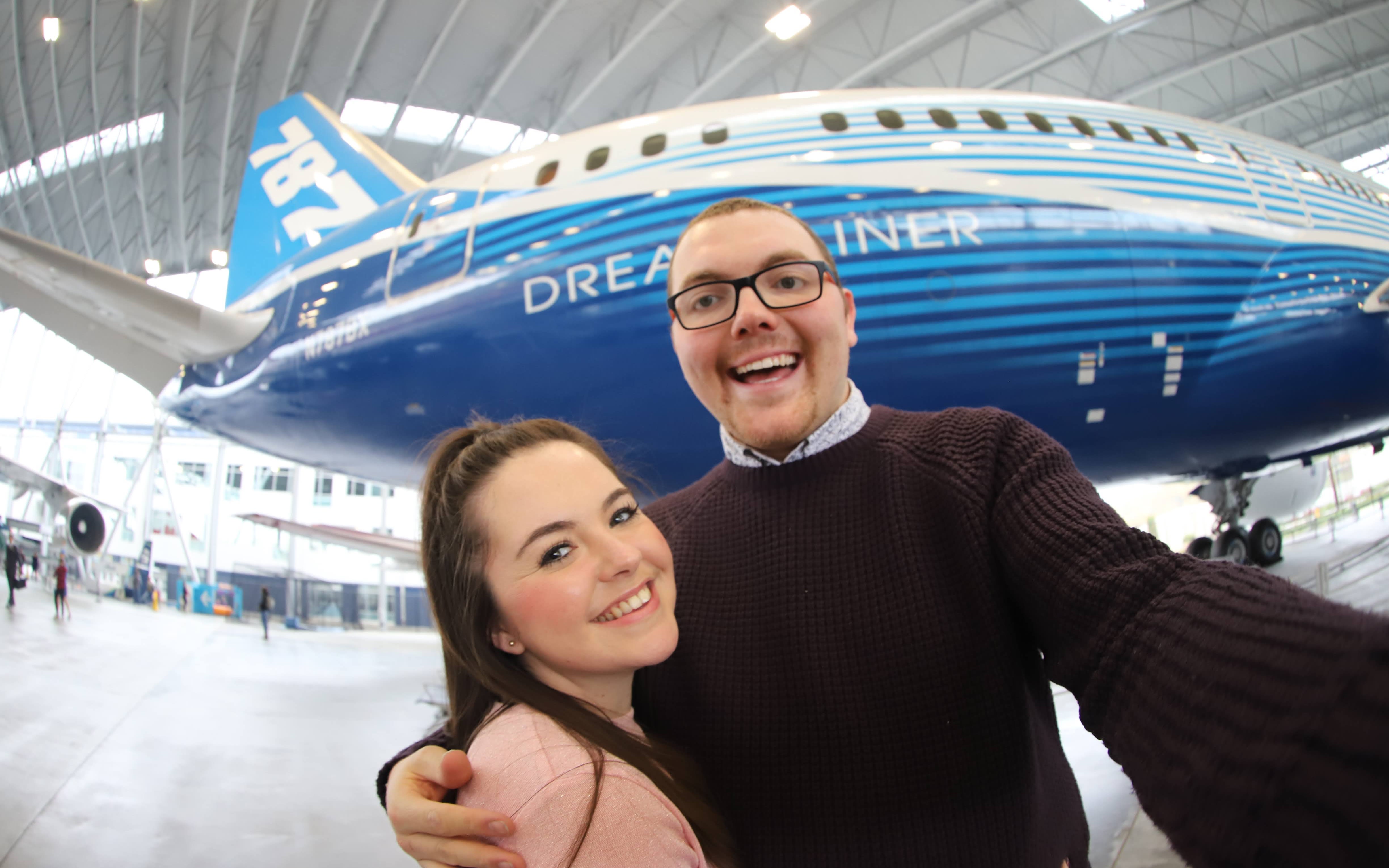 An image of Bradley and Amber in front of a Dreamliner 787