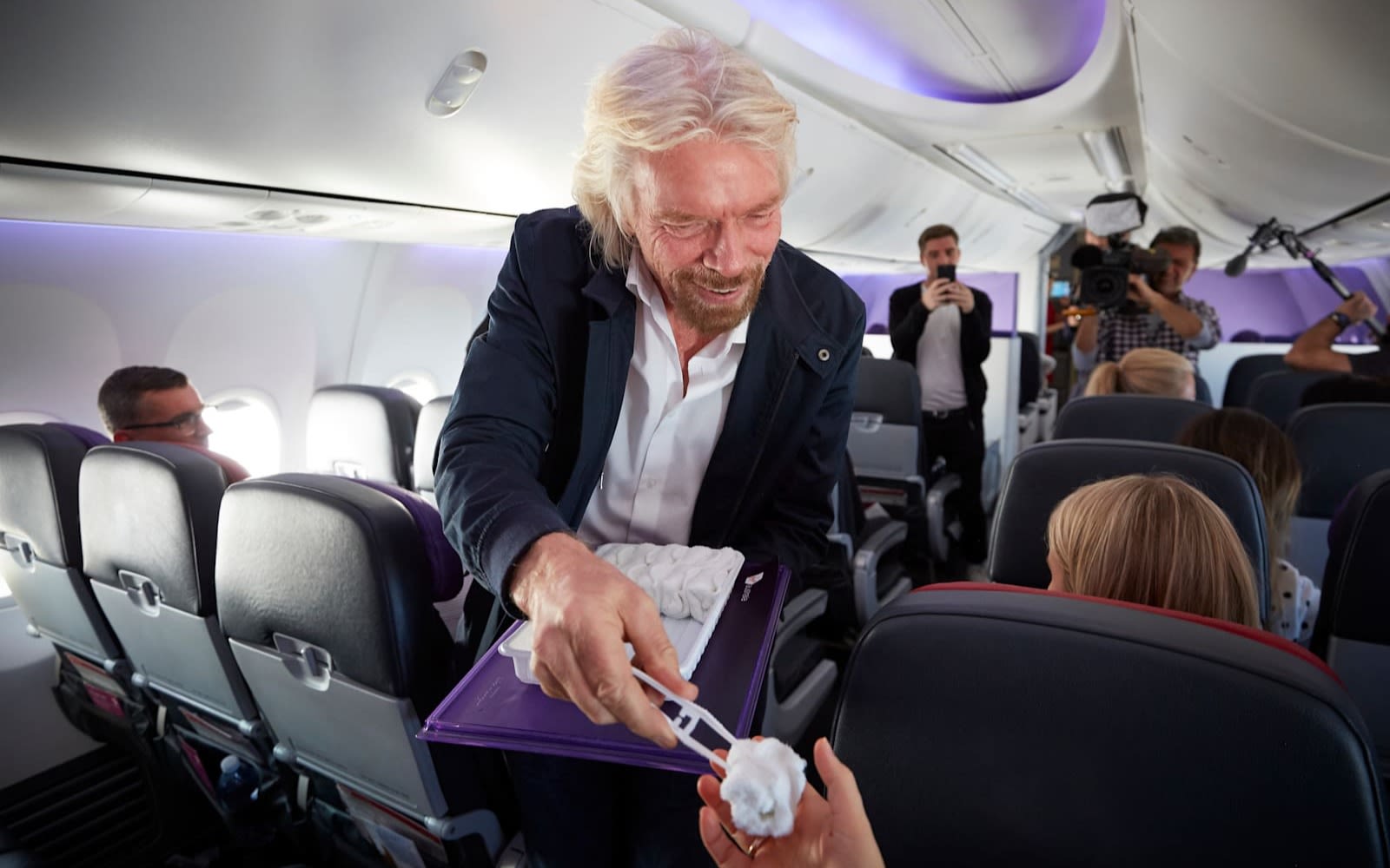 Richard Branson serving hot towels on Virgin Australia's meditation flight in 2018