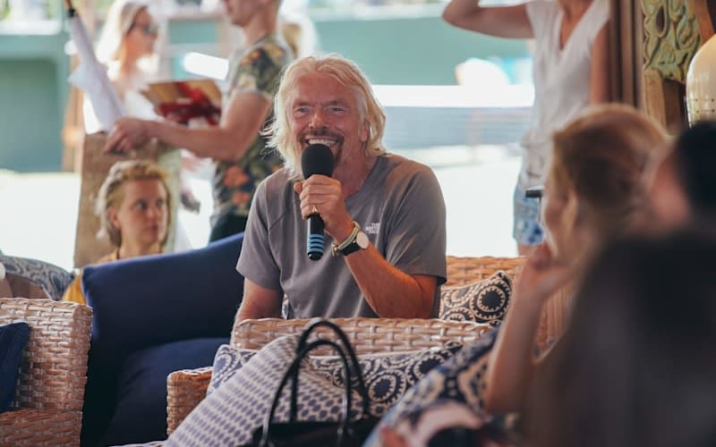 Richard Branson speaking into a microphone