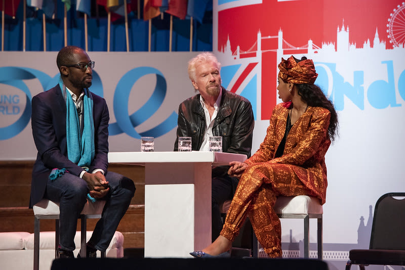 Richard Branson and Jaha Dukarah on stage at One Young World in 2019