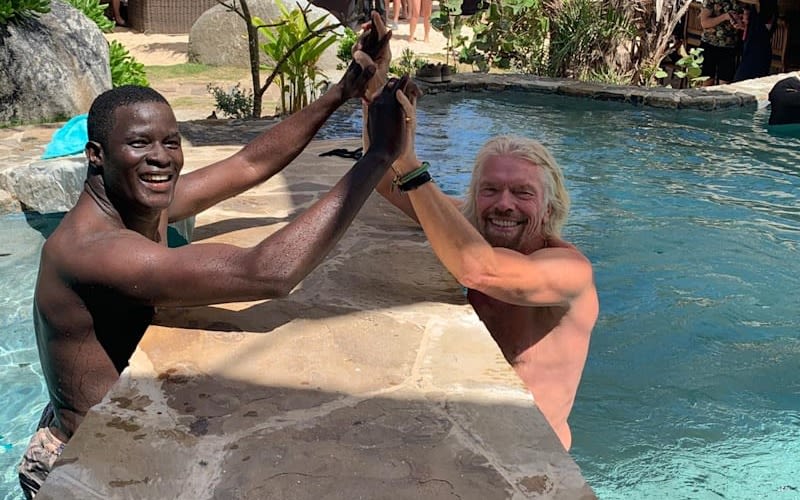 Richard Branson teaching swimming lessons in the pool 