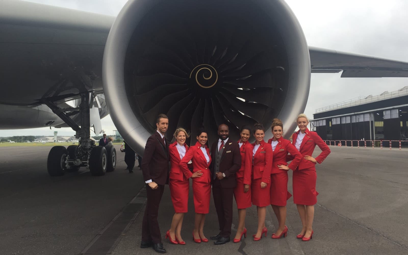 Cabin crew members standing beside an aircraft