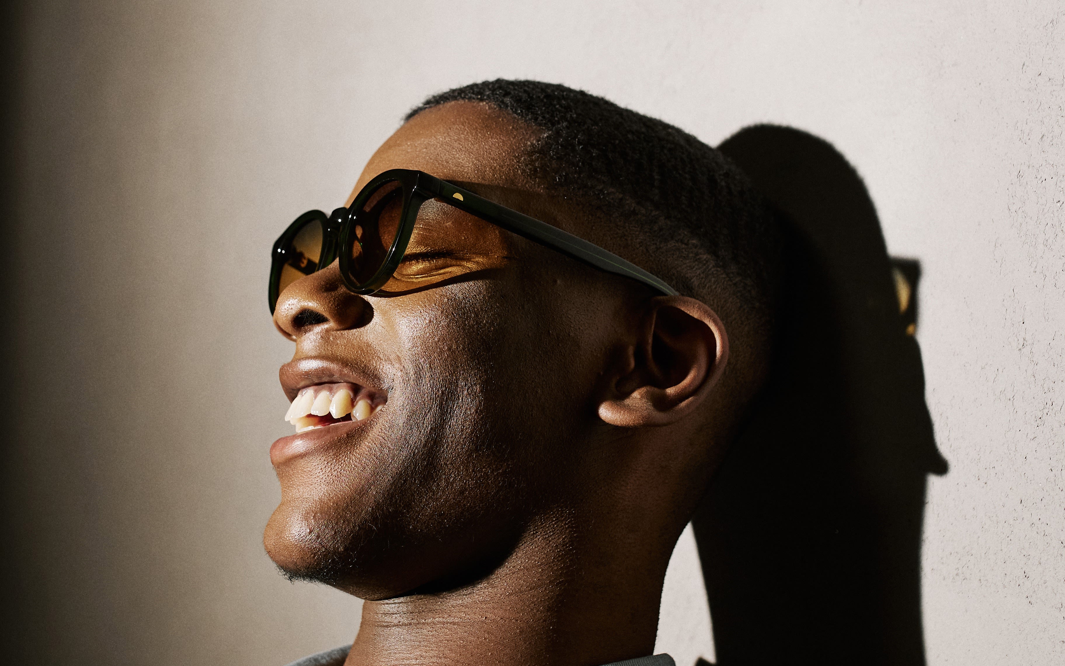 Man smiling while wearing Tens sunglasses