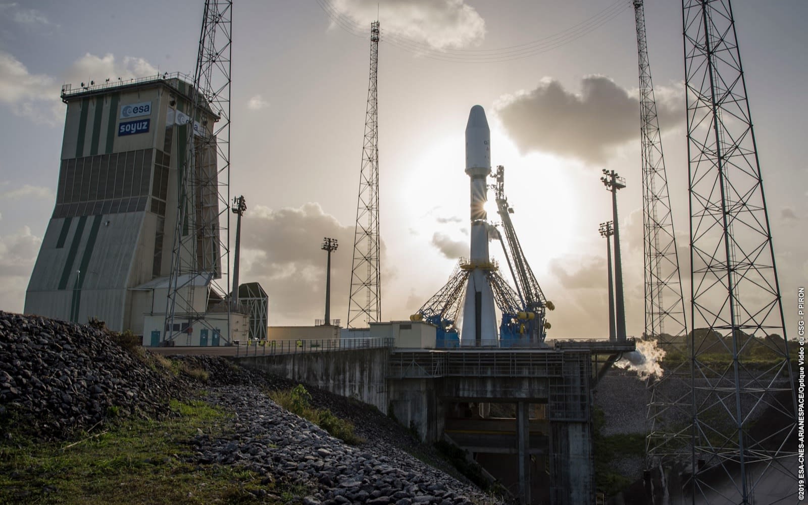 Rocket about to be launched with image of sun behind rocket 