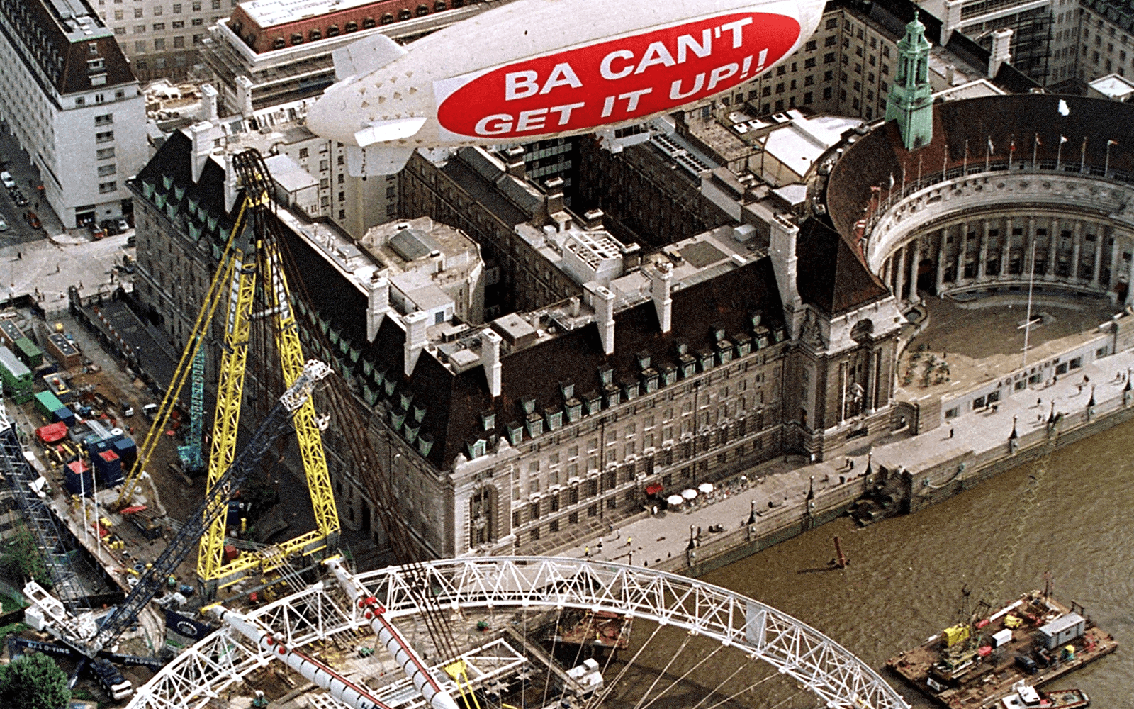 A blimp reading BA can't get it up flies above the London Eye