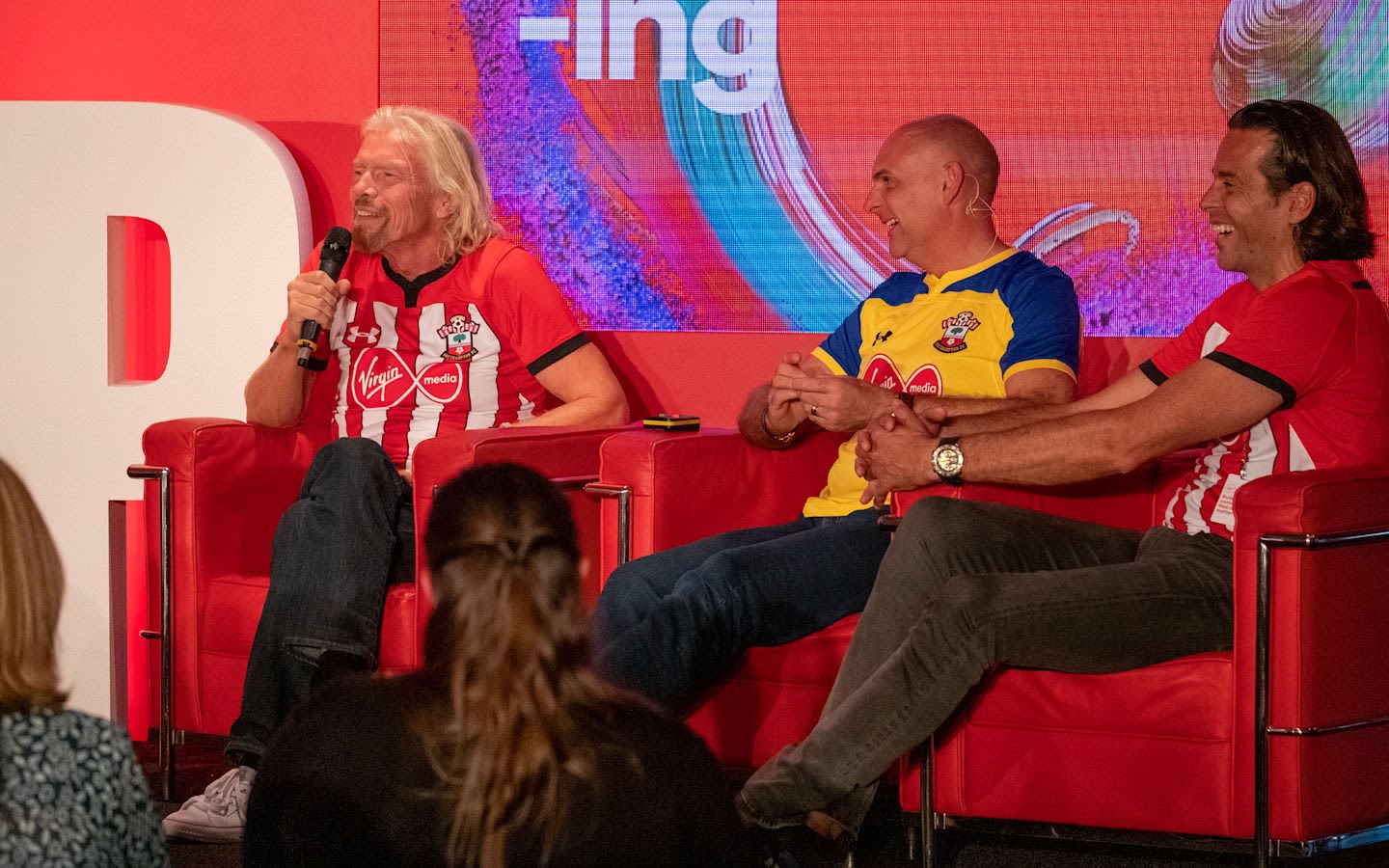 Richard Branson speaking on a Virgin Media panel with the Southampton football team