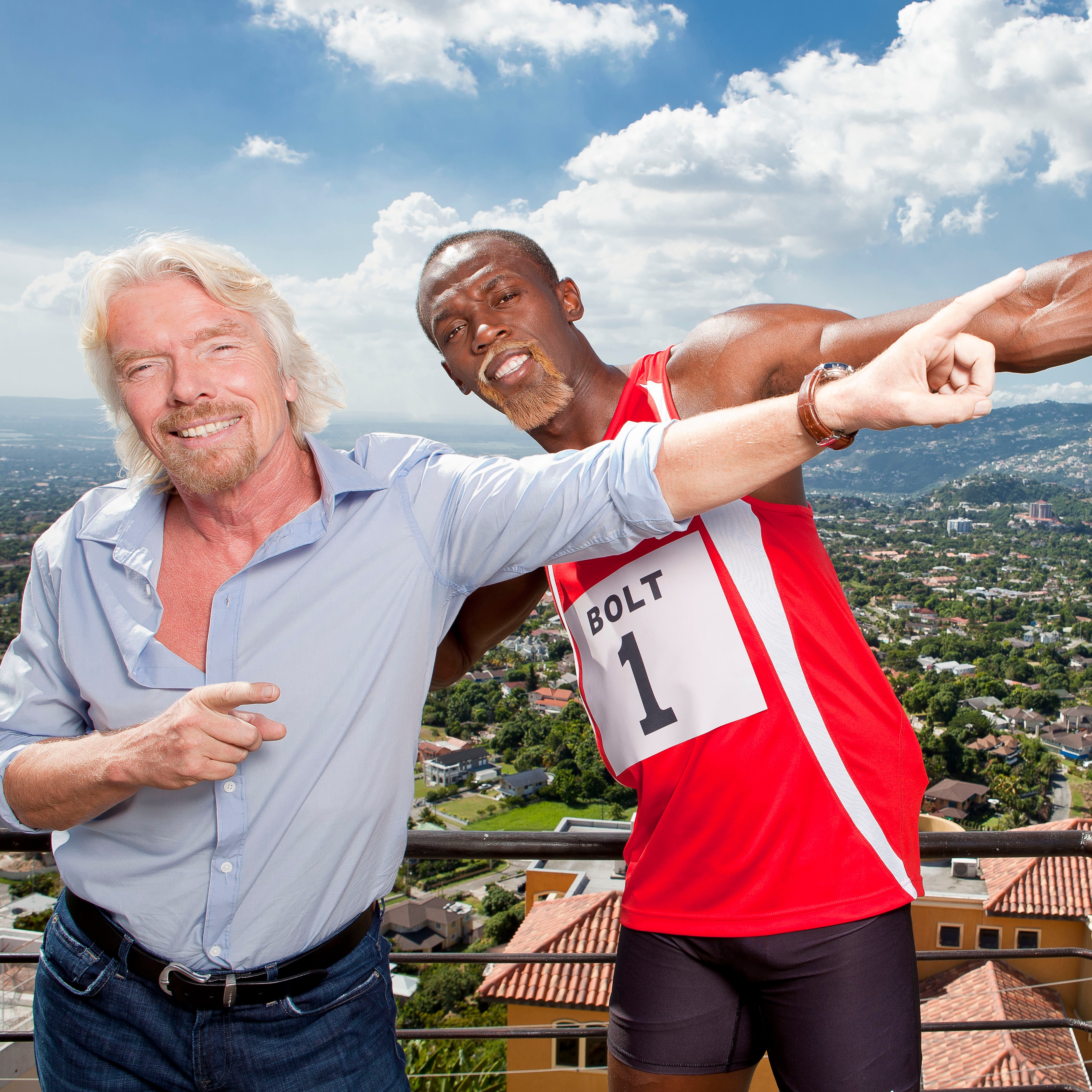 Richard Branson and Usain Bolt smile and pose together