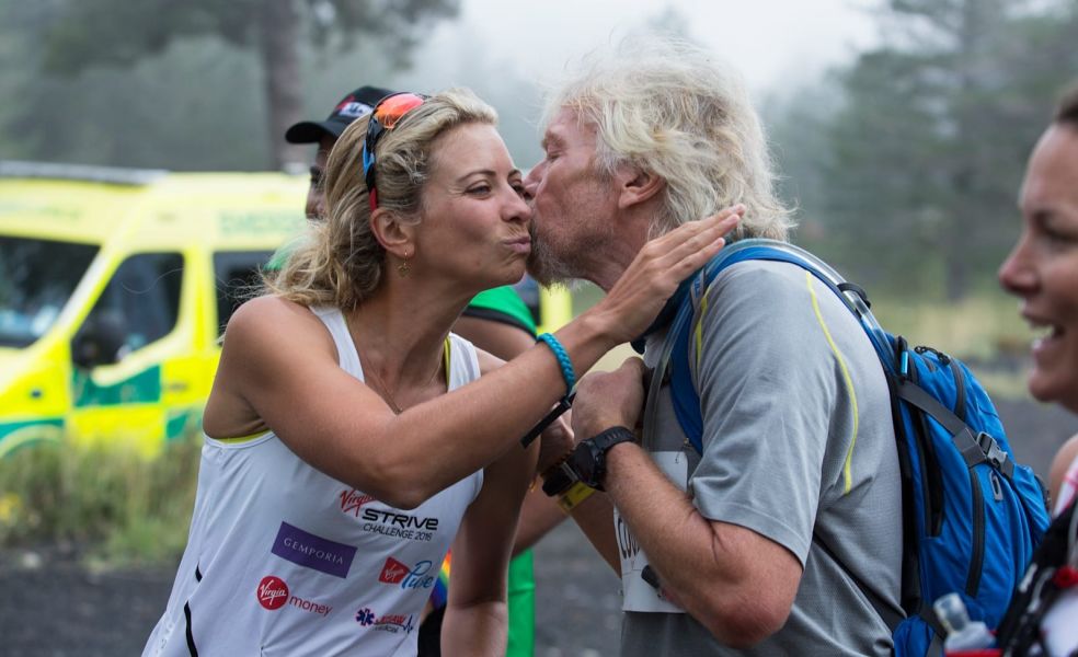 Richard Branson kisses a race participant on the cheek