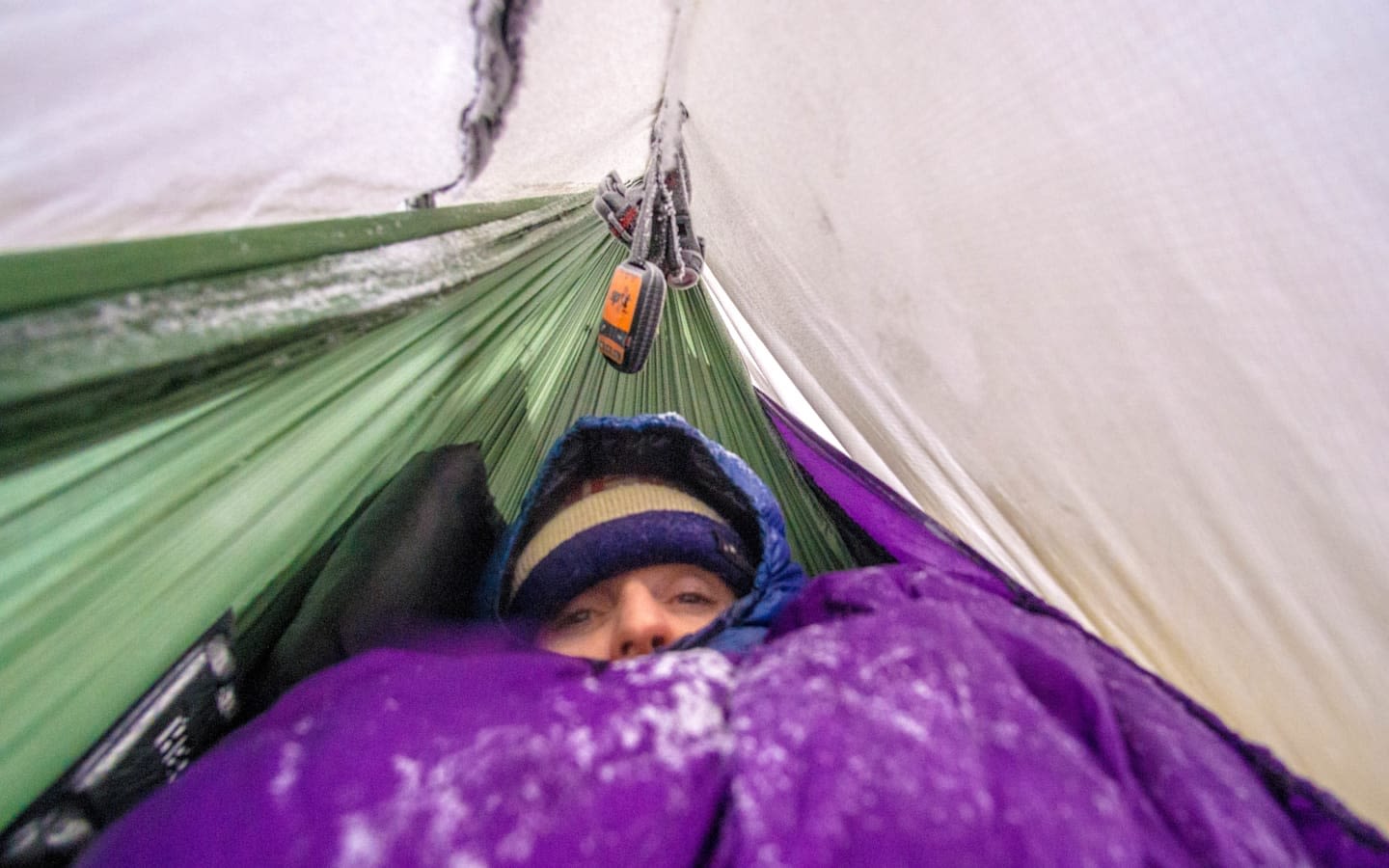 Person in a tent looking cold 