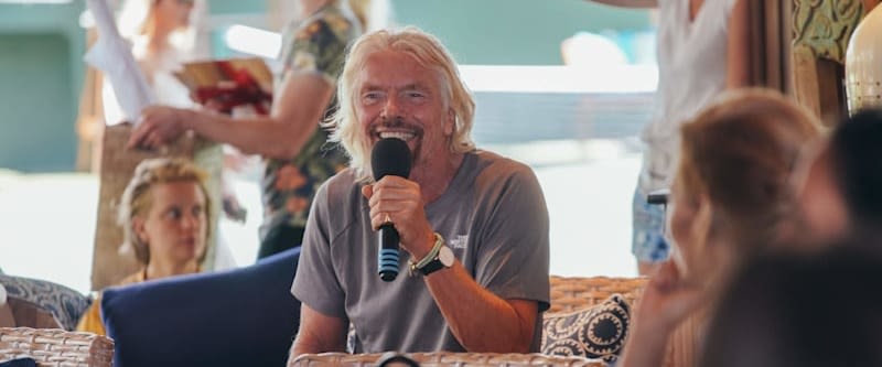 Richard Branson smiling while speaking at a Virgin Unite event
