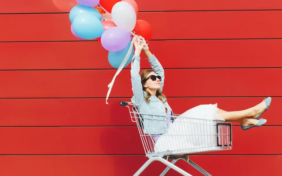 An image of a woman in a trolley holding balloons