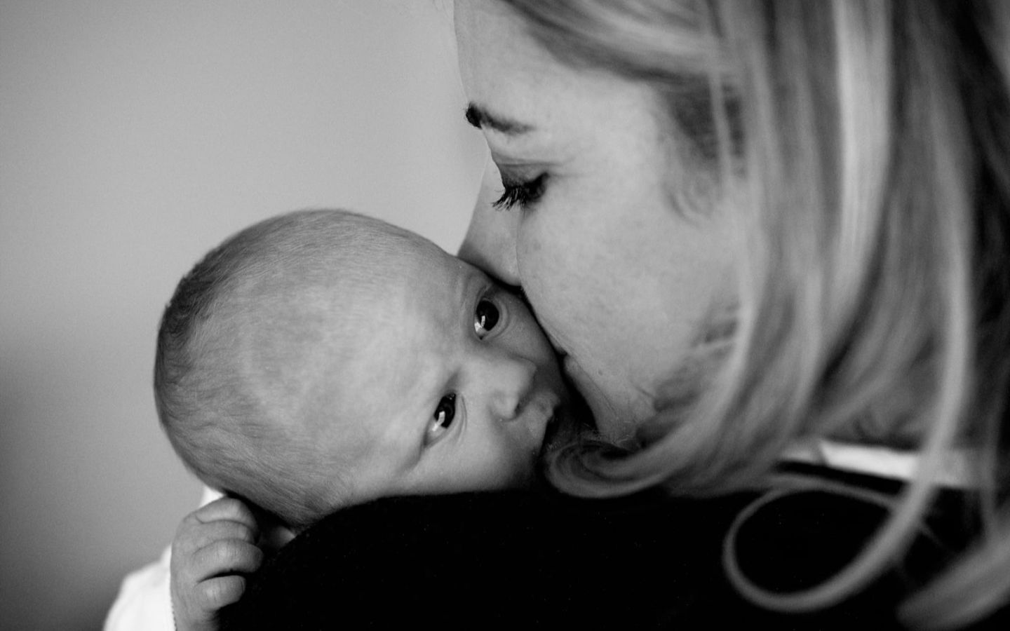 Black and white photo of Holly Branson holding baby Lola
